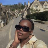 A picture of a blag girl on the street of castle Combe